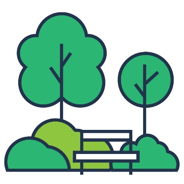A park bench next to some trees and bushes.